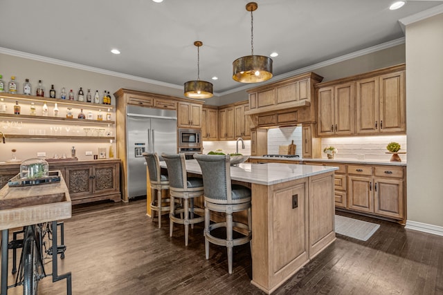 kitchen with built in appliances, dark wood finished floors, tasteful backsplash, and a breakfast bar area