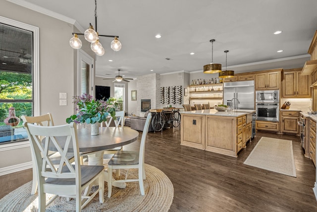 dining space with crown molding, ceiling fan, and recessed lighting