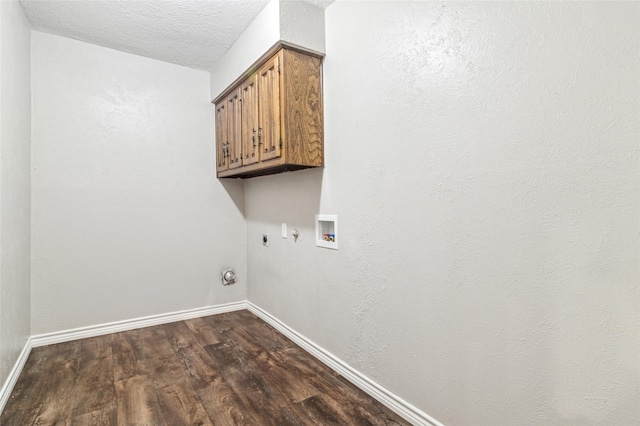clothes washing area with cabinet space, gas dryer hookup, baseboards, electric dryer hookup, and dark wood-type flooring
