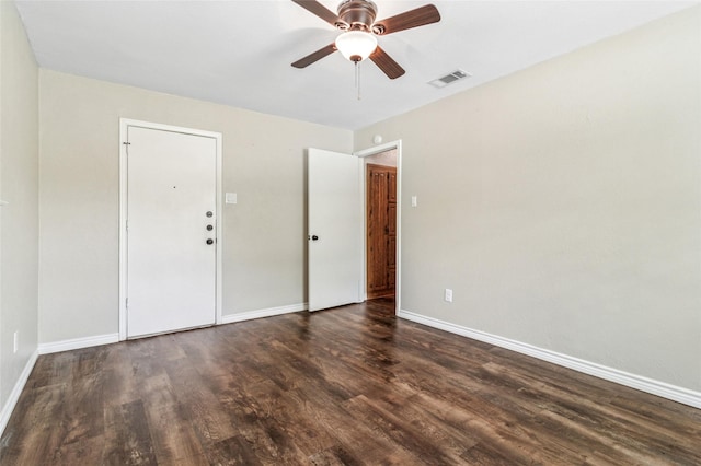 empty room featuring visible vents, a ceiling fan, baseboards, and wood finished floors