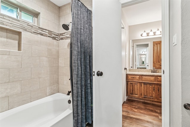 full bathroom featuring shower / bath combo with shower curtain, wood finished floors, and vanity
