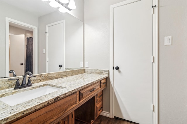full bath featuring vanity, curtained shower, and wood finished floors