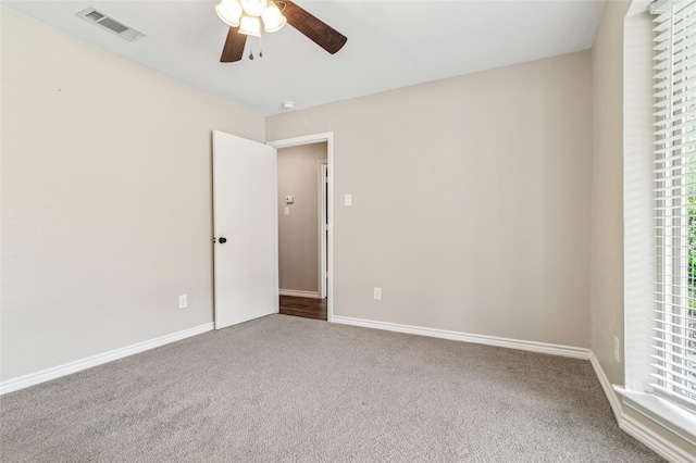 unfurnished bedroom featuring visible vents, carpet flooring, baseboards, and a ceiling fan