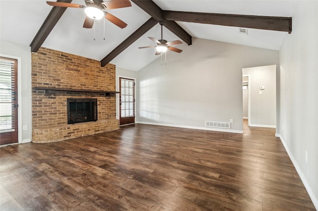 unfurnished living room with a brick fireplace, ceiling fan, and wood finished floors