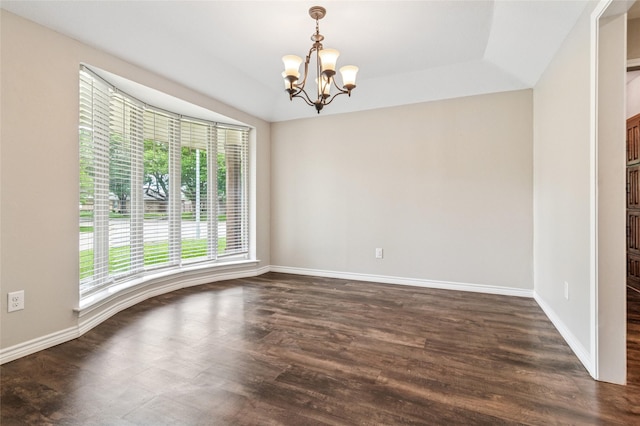 empty room featuring an inviting chandelier, baseboards, and dark wood-type flooring