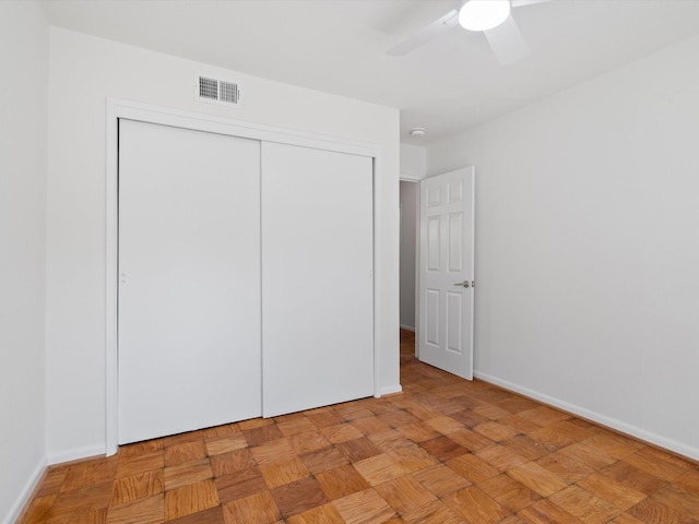 unfurnished bedroom with visible vents, baseboards, and a closet