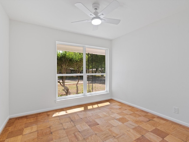 unfurnished room with baseboards and ceiling fan