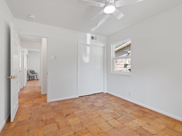unfurnished bedroom featuring baseboards, visible vents, ceiling fan, and a closet