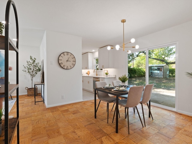 dining space featuring baseboards and an inviting chandelier