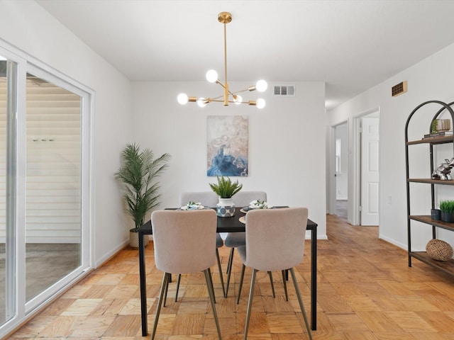 dining area featuring visible vents, baseboards, and an inviting chandelier