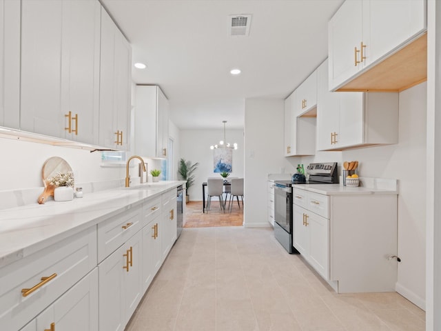 kitchen featuring white cabinets, appliances with stainless steel finishes, a sink, and visible vents