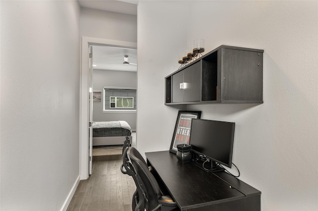 office with a ceiling fan, baseboards, and wood finished floors