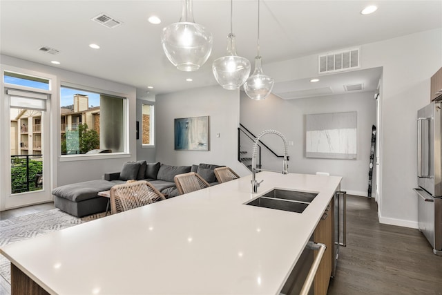 kitchen featuring a sink, light countertops, and visible vents