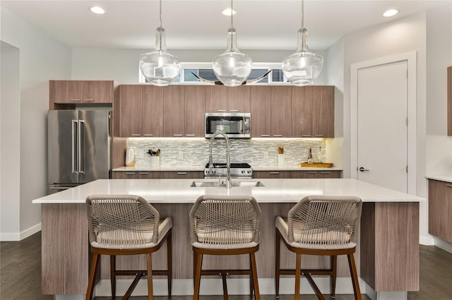 kitchen featuring light countertops, appliances with stainless steel finishes, and tasteful backsplash
