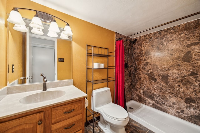 bathroom featuring vanity, toilet, and a stall shower