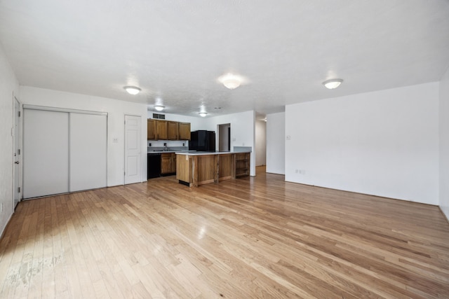 unfurnished living room featuring visible vents and light wood-style flooring