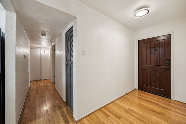 interior space featuring light wood-style floors and baseboards