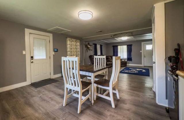 dining room with baseboards and wood finished floors