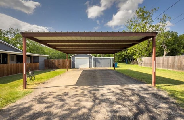 view of parking featuring fence and a detached garage