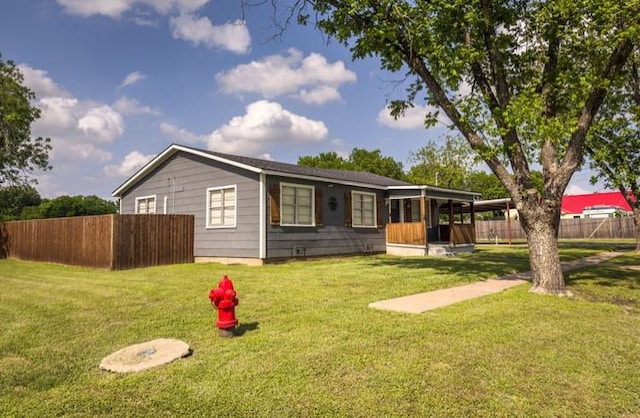ranch-style house with fence and a front yard