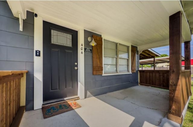 view of exterior entry with covered porch