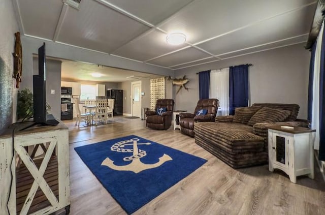 living room with visible vents and wood finished floors