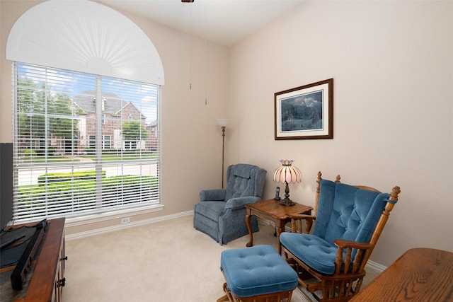 sitting room with plenty of natural light, a ceiling fan, carpet, and baseboards