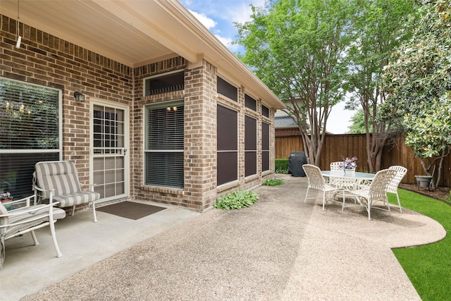 view of patio / terrace featuring outdoor dining area and fence