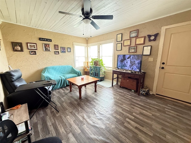 living room with a textured wall, a ceiling fan, and wood finished floors