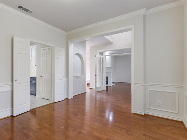 1524 Santa Fe Trl, Carrollton, TX 75007 - spare room with visible vents, ornamental molding, and wood finished floors