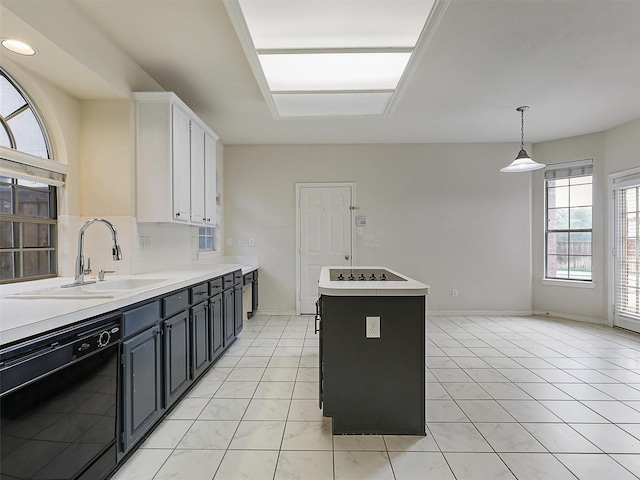 kitchen with white cabinets, a sink, light countertops, a kitchen island, and black appliances