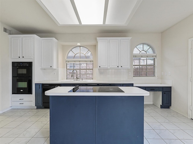 1524 Santa Fe Trl, Carrollton, TX 75007 - kitchen with a sink, marble finish floor, black appliances, and light countertops