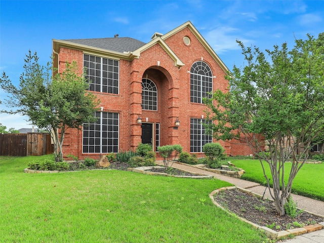 1524 Santa Fe Trl, Carrollton, TX 75007 - view of front of property featuring fence, roof with shingles, brick siding, and a front yard