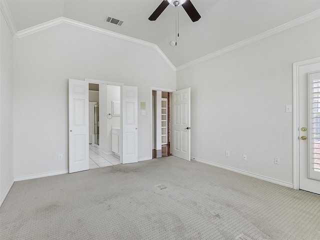 unfurnished bedroom with crown molding, vaulted ceiling, light colored carpet, and visible vents