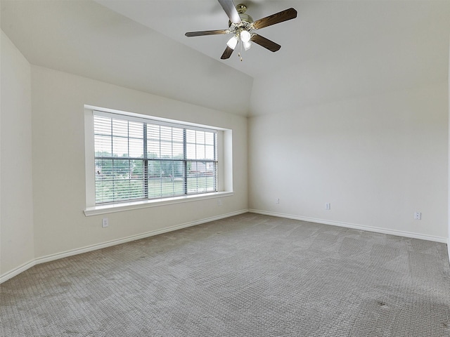 spare room featuring carpet flooring, a ceiling fan, baseboards, and lofted ceiling