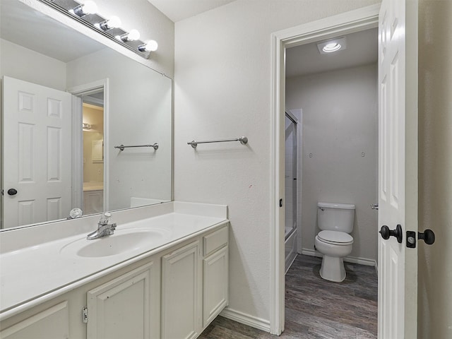 bathroom featuring shower / tub combination, vanity, toilet, baseboards, and wood finished floors