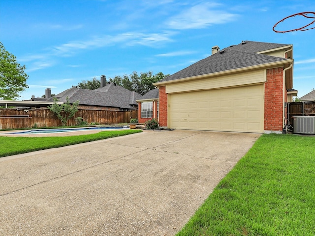 view of front facade with concrete driveway, brick siding, an attached garage, and fence