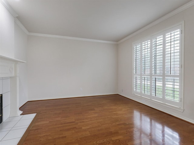 unfurnished living room with ornamental molding, wood finished floors, and a healthy amount of sunlight