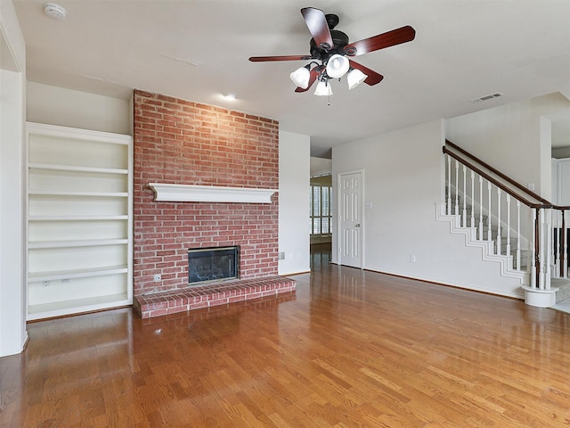 1524 Santa Fe Trl, Carrollton, TX 75007 - unfurnished living room with visible vents, a ceiling fan, wood finished floors, and stairway