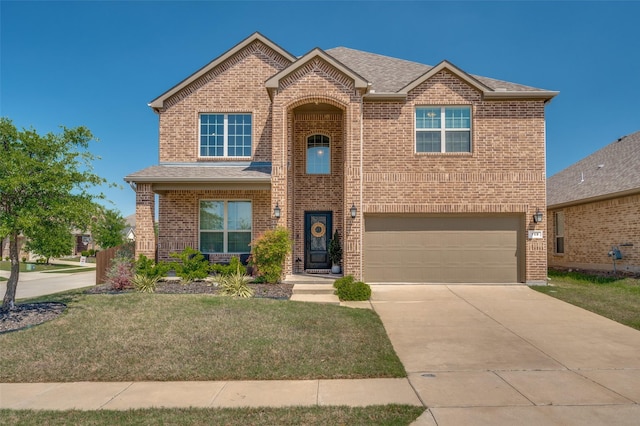 traditional home with brick siding, an attached garage, driveway, and a front yard