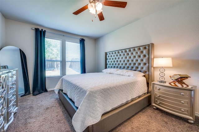 carpeted bedroom with baseboards and a ceiling fan