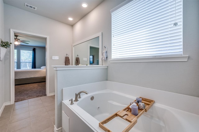 ensuite bathroom featuring connected bathroom, a whirlpool tub, tile patterned floors, and visible vents