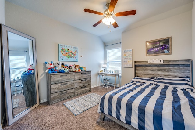 carpeted bedroom with baseboards, ceiling fan, and vaulted ceiling