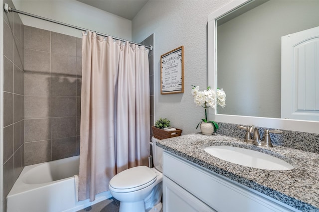 full bathroom with vanity, a textured wall, toilet, and shower / bath combination with curtain