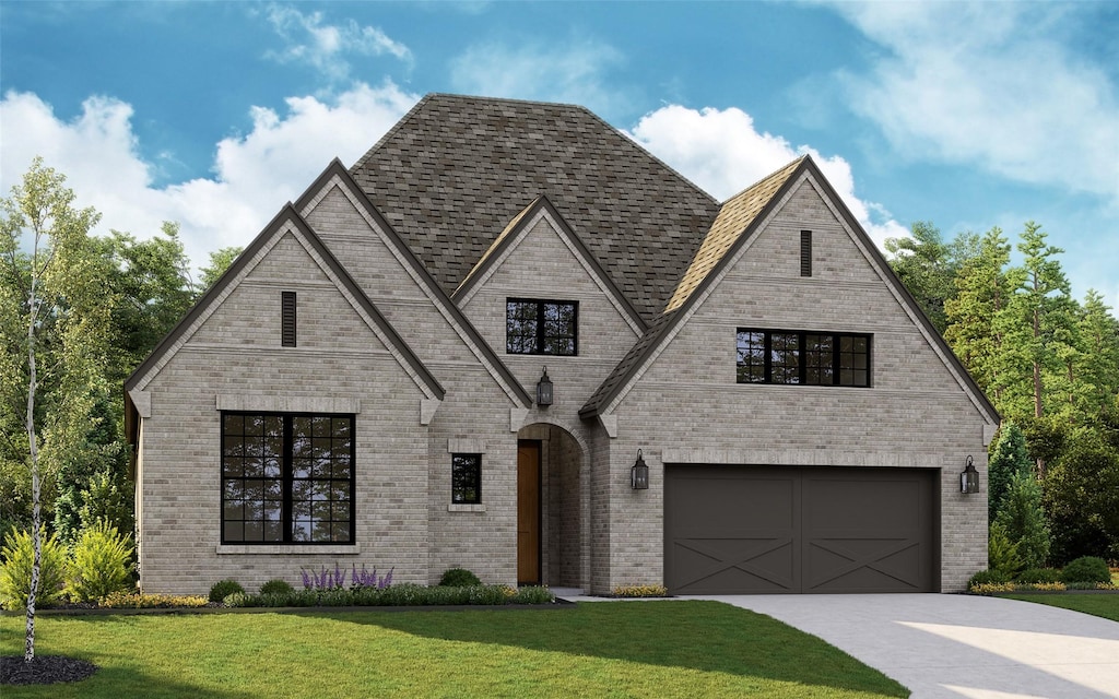 french country style house featuring a garage, concrete driveway, brick siding, and a front yard