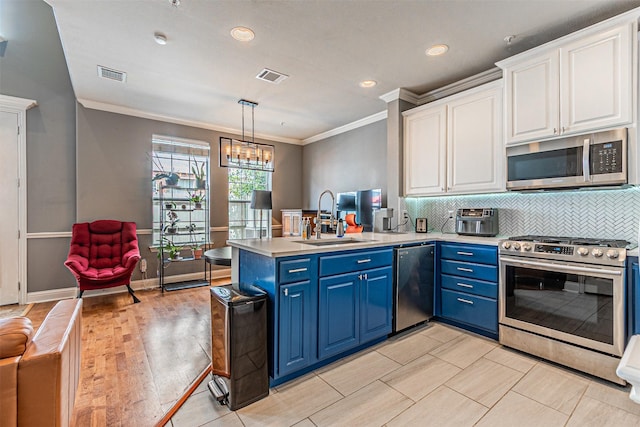 kitchen with visible vents, ornamental molding, blue cabinets, a sink, and appliances with stainless steel finishes