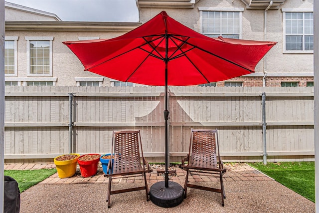 view of patio featuring fence