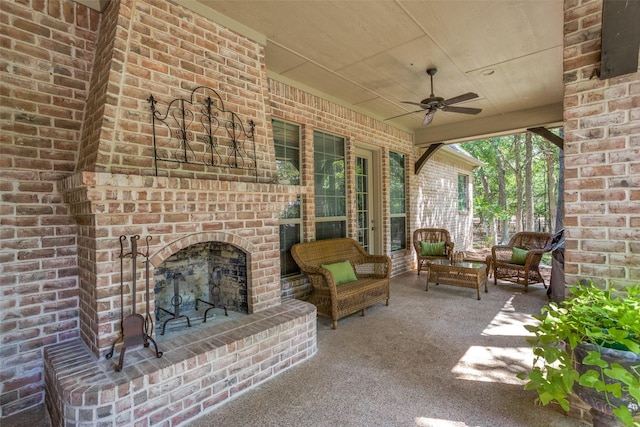 view of patio with a ceiling fan and an outdoor living space with a fireplace