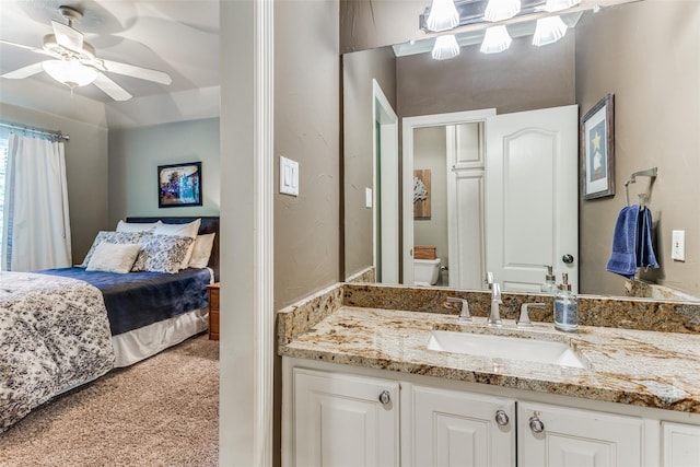 bathroom featuring toilet, a ceiling fan, and vanity