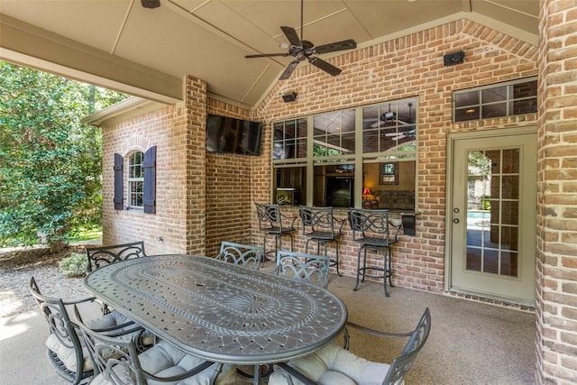 view of patio / terrace featuring ceiling fan, exterior bar, and outdoor dining space